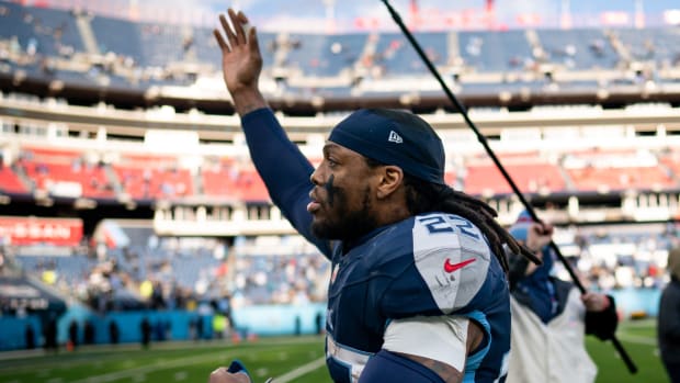 Titans running back Derrick Henry waves to the crowd as he runs off the field.